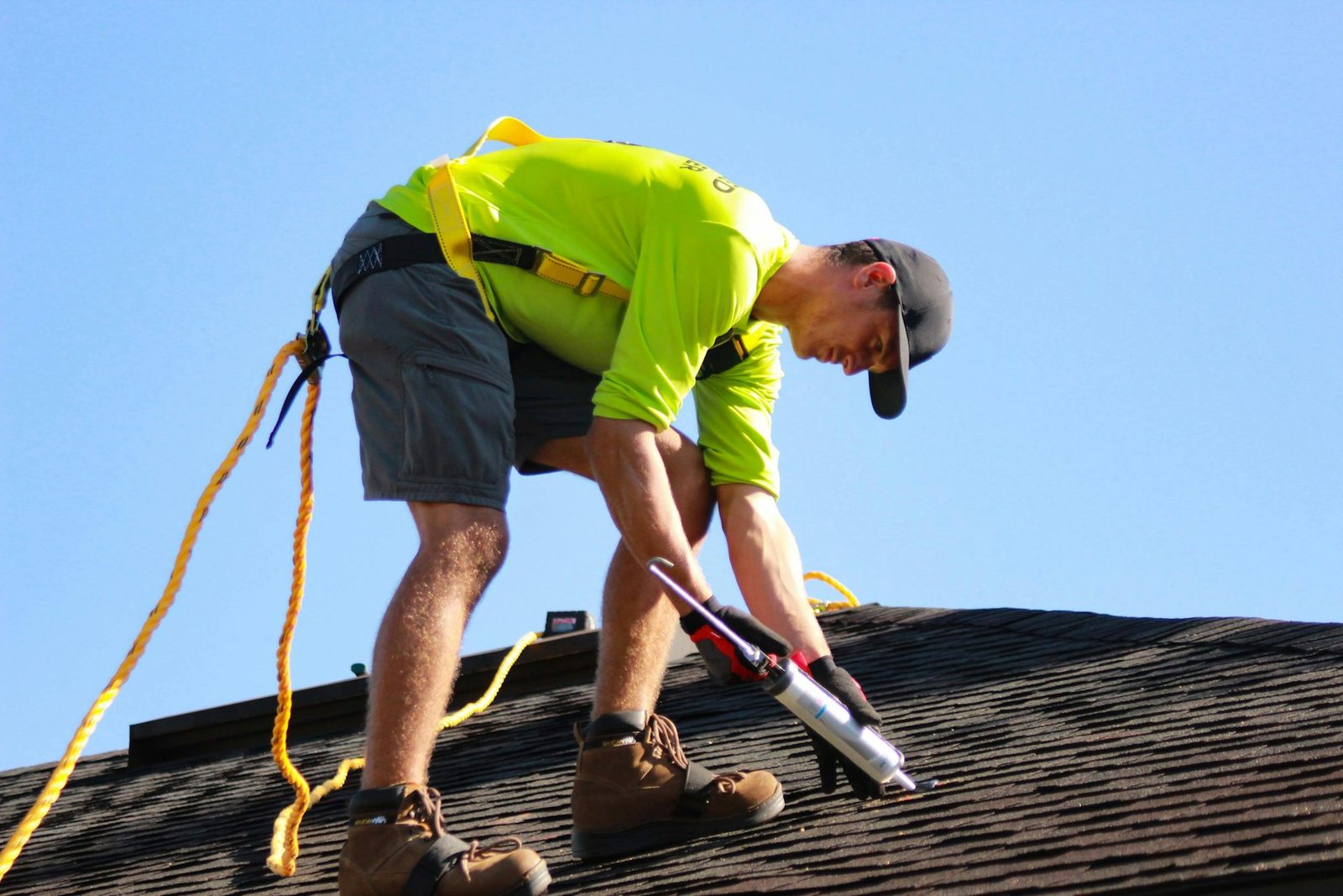 Roofer working on residential shingles in Northwest Florida